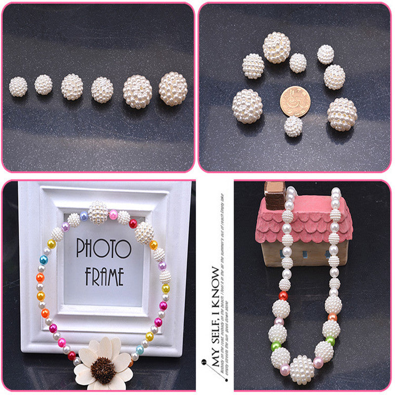 A collection of white pearl beads and a finished pearl necklace displayed on a photo frame.