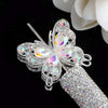 Silver crystal butterfly beads with iridescent accents attached to a silver cylindrical bead.
