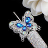 Silver crystal butterfly beads with blue gemstones and a textured silver bead.
