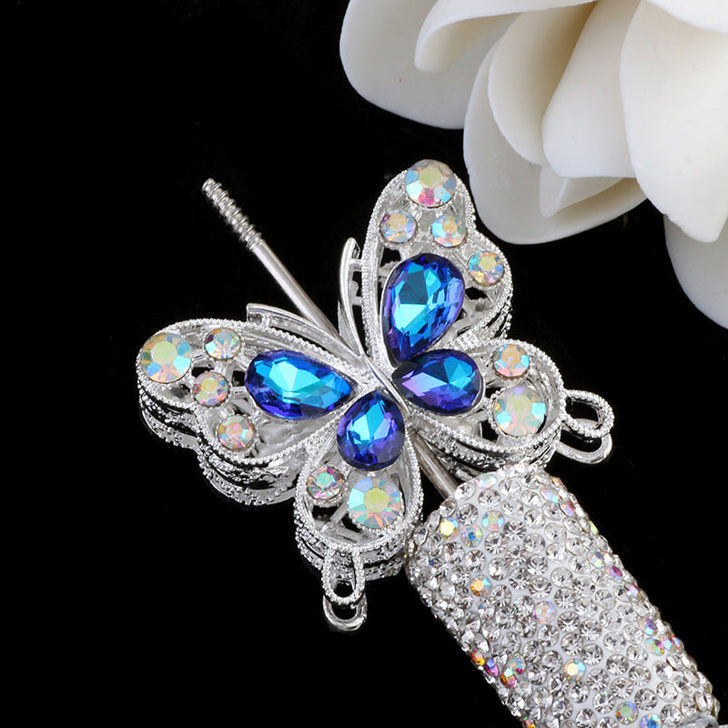 Silver crystal butterfly beads with blue gemstones and a textured silver bead.