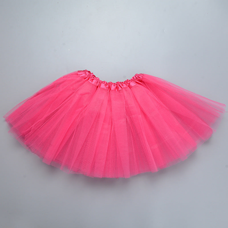 A bright pink three-layer tutu skirt for girls displayed flat.