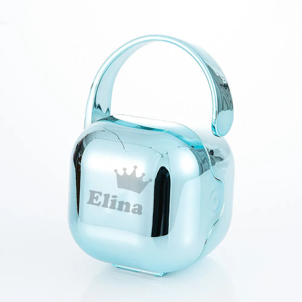 A clear blue silicone storage case for a baby pacifier with a crown design on the side.