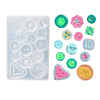 A clear silicone mold tray containing various colorful resin buttons and shapes for DIY jewelry making