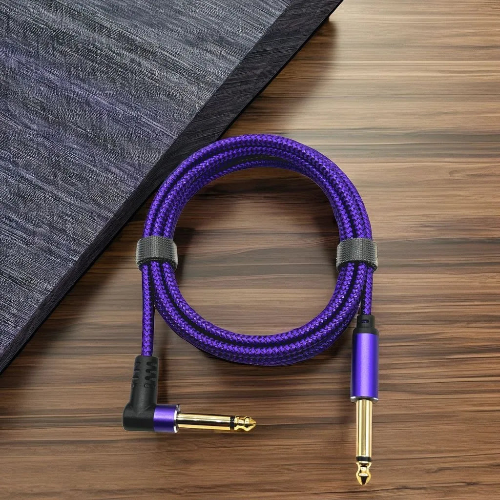 Purple right-angle instrument cable with a 6.35mm connector lying on a wooden surface.