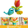 A bright orange and yellow sunflower watering bath toy with a suction cup is shown in various contexts.