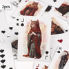 A playing card featuring a vintage illustration of a cat wearing a red cloak.