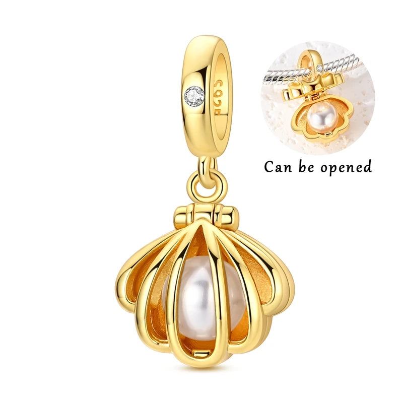 Gold-tone pendant set featuring a starfish, sea turtle, and whale shark charm with an opening mechanism.