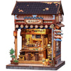 A detailed 3D wooden book nook kit featuring a traditional Japanese storefront with LED lighting.