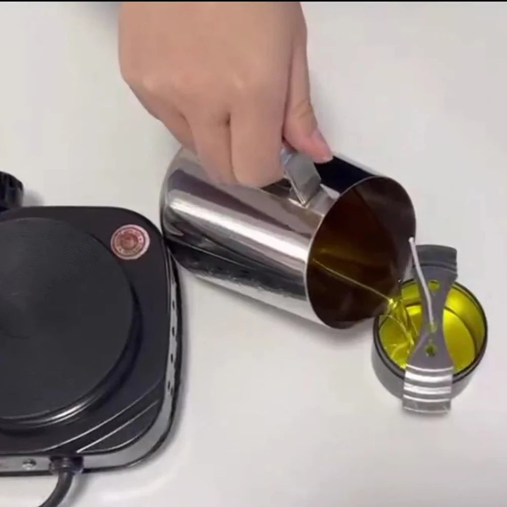 A hand is pouring liquid into a metal melting pot part of a complete candle making kit.