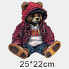 A cute brown bear wearing a red jacket and hood, sitting down.
