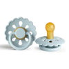 A light blue natural latex baby pacifier with a yellow nipple and a decorative flower-like silicone ring.