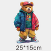 A fluffy brown bear wearing a red baseball cap and a blue jacket, standing against a white background.