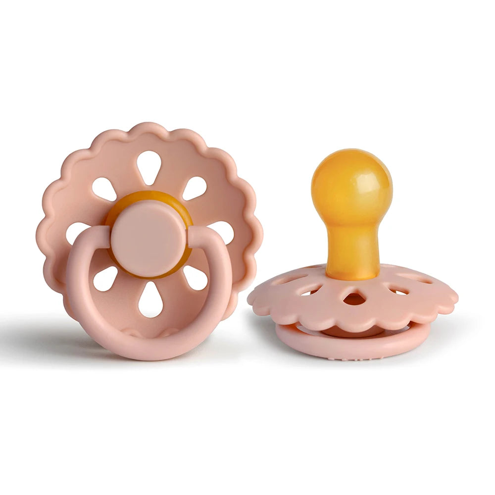 A pink natural latex baby pacifier with a yellow silicone top, shown against a white background.