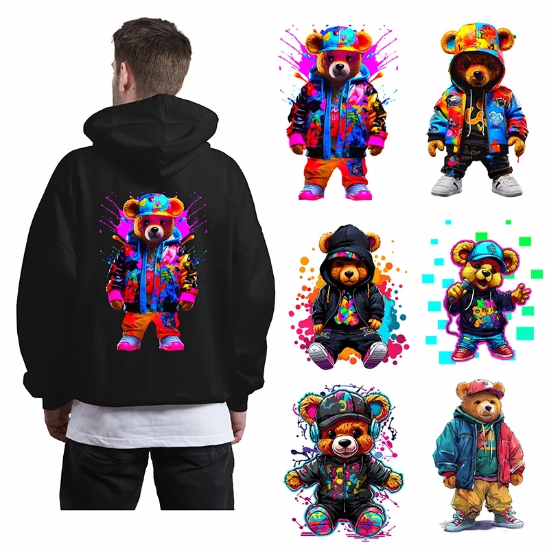 A black hoodie featuring a colorful graffiti bear graphic and various iron-on patches of bears.