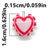 A small, heart-shaped glass bead with red and white accents for jewelry making.