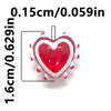 A red heart shape made from lampwork glass beads, shown next to a measurement scale.