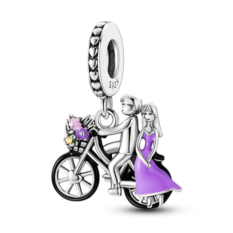Sterling silver charm bead pendant featuring a bicycle, key, and a couple.