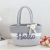 A gray braided cotton tote bag with a handle and the word Hello embroidered on the front.