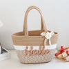 A beige braided cotton tote bag with a handle and a white flower decoration.