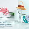 A set of silicone pacifiers and teats shown with a disassembled component and reassembled version on a white surface.