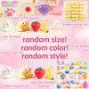 A collection of various soft, squishy toys including a pink paw print, a white cat, a purple heart, and various food-shaped i