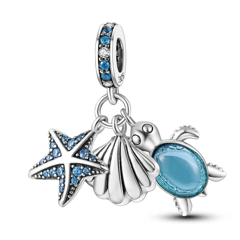 Sterling silver charm pendant set featuring a starfish, sea turtle, and whale shark.