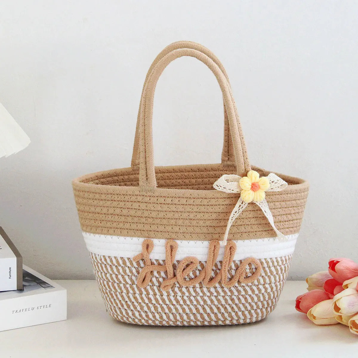 A beige braided cotton tote bag with white stripes and a yellow flower detail.