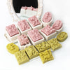 A collection of silicone soap molds featuring pink and green floral designs, including rose and butterfly patterns.
