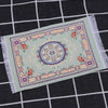 Handwoven Turkish style miniature carpet mat with floral patterns in light green and purple tones
