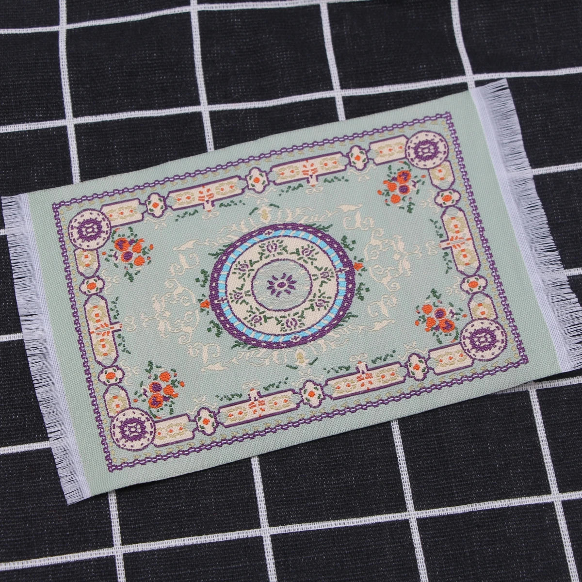 Handwoven Turkish style miniature carpet mat with floral patterns in light green and purple tones