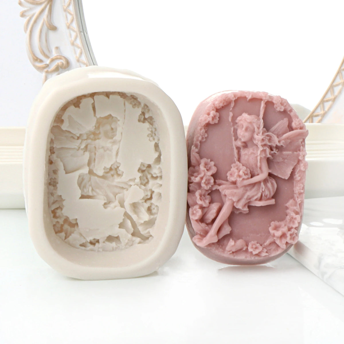 A silicone soap mold featuring a 3D flower fairy design with an angel girl, rose, and butterfly motif.