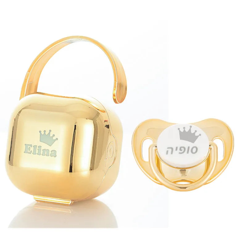 Gold personalized baby pacifier with a crown design and storage case