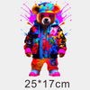 A fluffy bear wearing a colorful jacket and hat with paint splatters, standing against a white background.