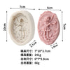 A pink silicone soap mold shaped like a fairy with a rose and butterfly design.