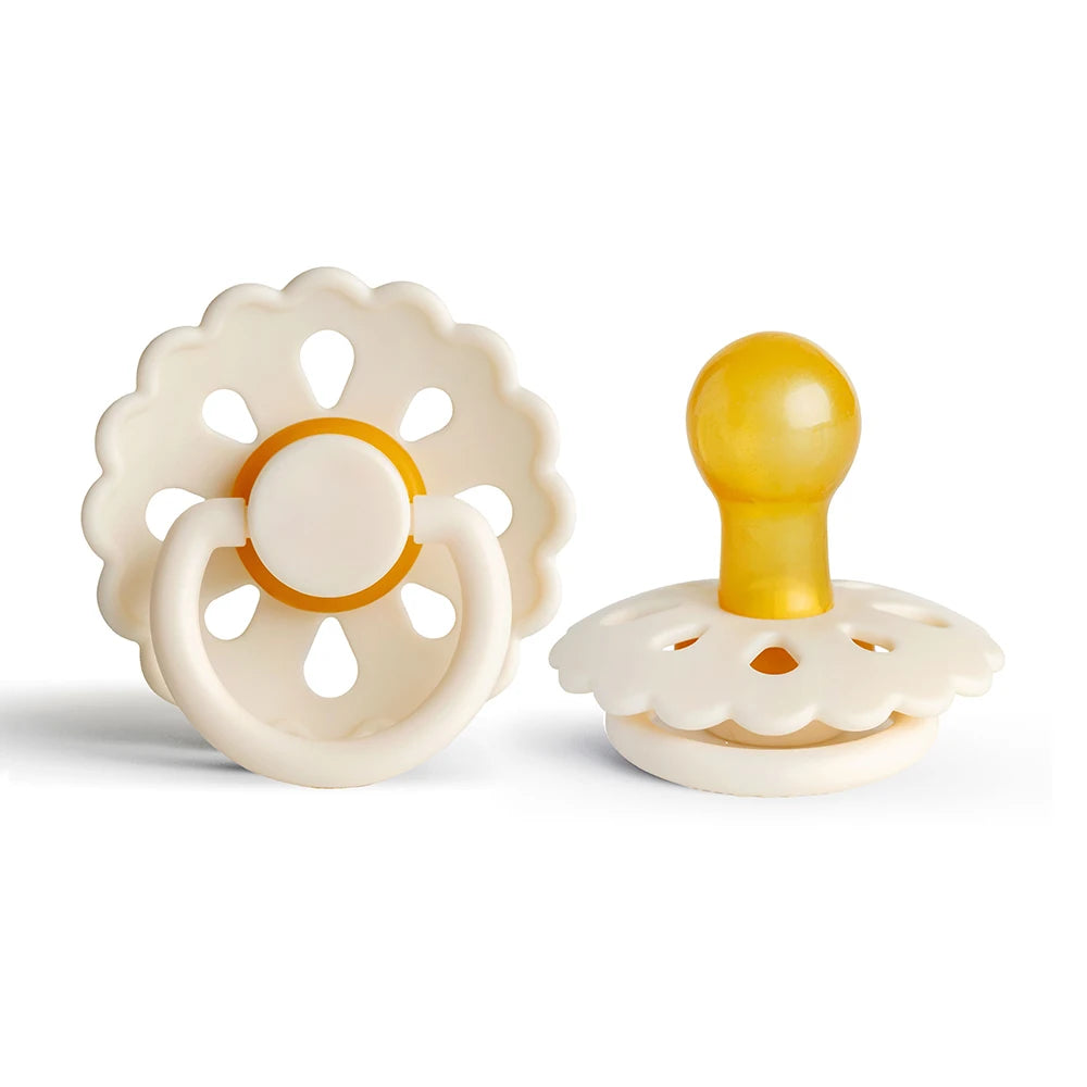 A white natural latex baby pacifier with a yellow silicone top and a flower-like design.