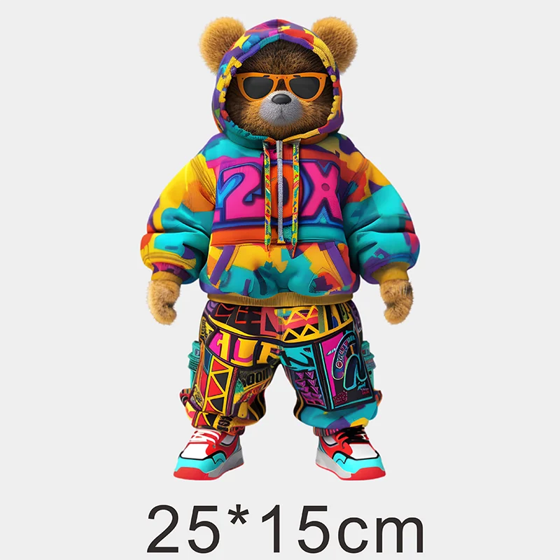 A fluffy brown bear wearing sunglasses and a colorful hoodie with graffiti patches on its clothing.
