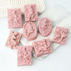 Pink silicone soap molds featuring 3D flower fairy, angel girl, rose, and butterfly designs.