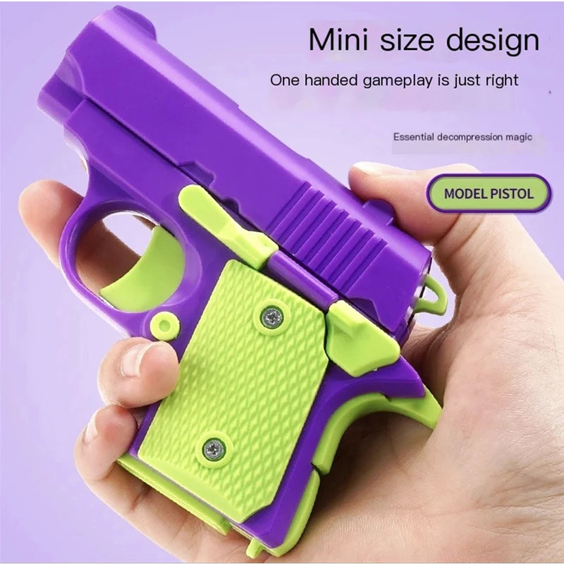 A hand holds a purple and lime green mini pistol toy with a slide mechanism.