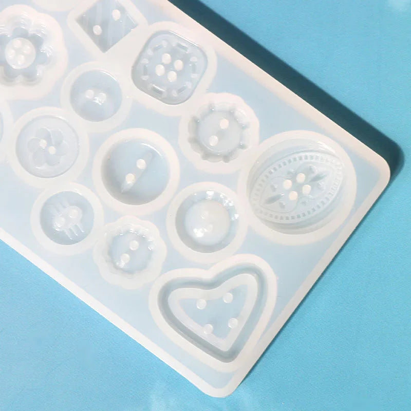 A silicone button resin casting mold with various shapes including circles, hearts, and floral designs.