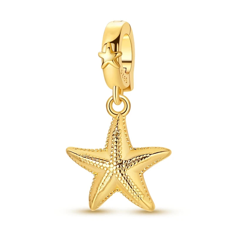 Gold-toned charm pendant set featuring a starfish, sea turtle, and whale shark.