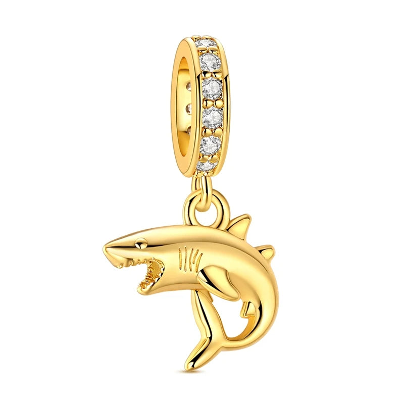 Gold-tone charm pendant set featuring starfish, sea turtle, and whale shark charms with clear stones.