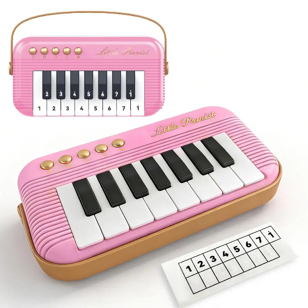 A pink mini piano keyboard with a white and black key layout and a separate numbered practice sheet.