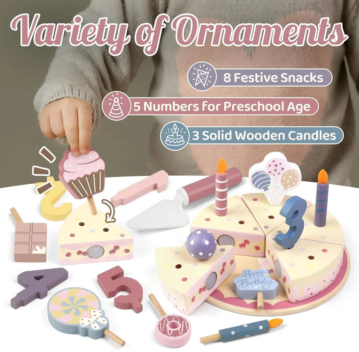 A variety of festive snacks and wooden candles displayed on a cake set for children's birthday play