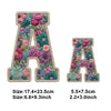 Iron-on patches shaped like the letter A featuring a colorful floral design