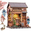 A detailed 3D wooden book nook kit featuring a traditional Japanese-style shop facade with intricate details and LED lighting