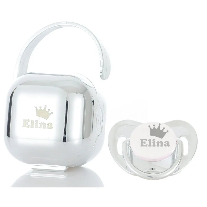 Silver personalized baby pacifier with a crown design and storage case