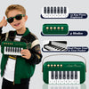 A smiling boy holds a portable mini piano keyboard toy in his hand.