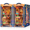 A colorful 3D wooden book nook kit featuring a detailed diorama of a plaza de los muertos with LED lighting.