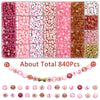Assortment of pink, red, and white acrylic beads with gold accents for jewelry making