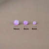 Three round glass beads of varying sizes (10mm, 8mm, and 6mm) are displayed on a neutral background.